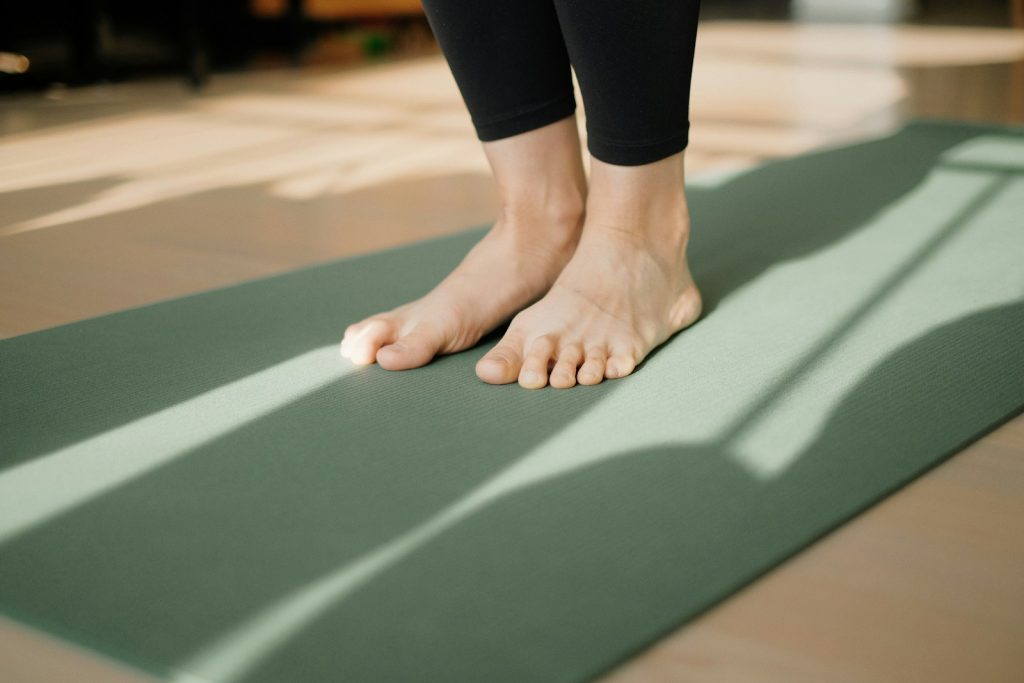 a person standing on a pilates mat on the floor
